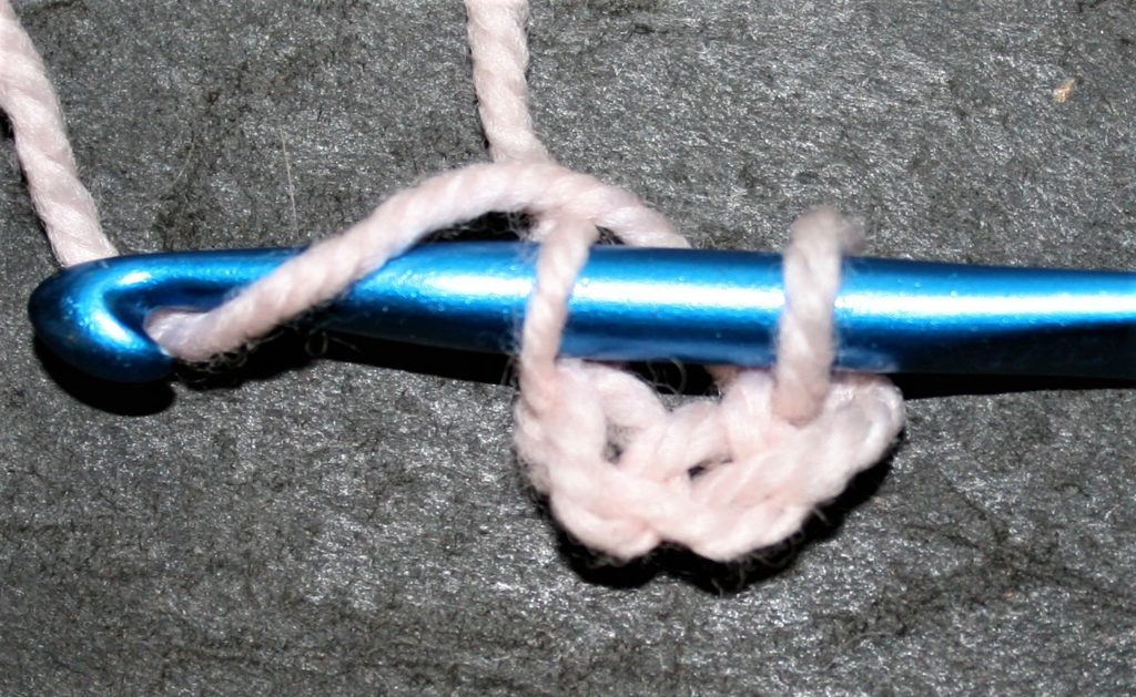 Forming a ring to crochet into, by creating a chain and slip stitching to the first chain created