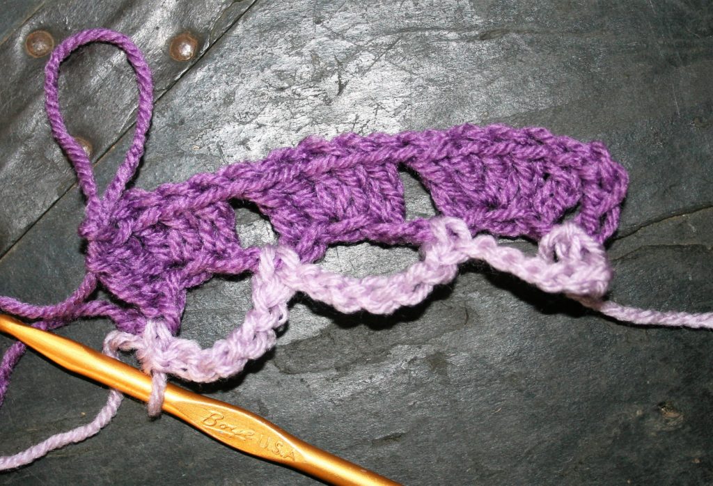Adding the first row of a new color in Reversible Shell crochet stitch is a chain loop